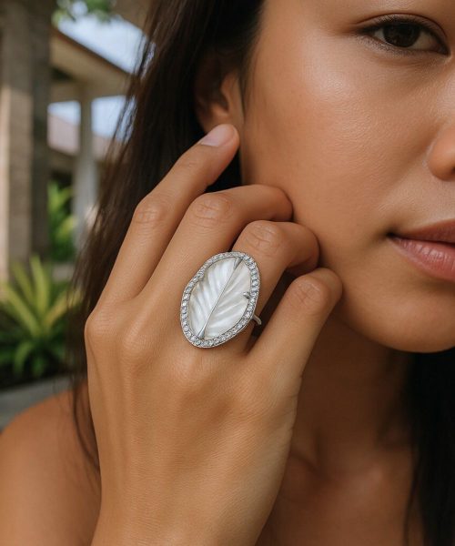 Close-up of woman wearing a large mother of pearl silver ring